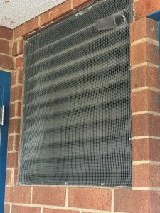 Louvered wall vent covered with heavy screen to keep bats and wildlife out, North Carolina